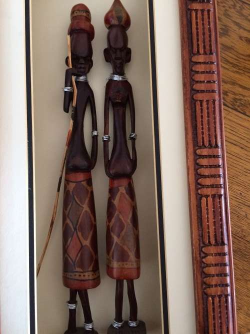 Tribal  carved figures in frame